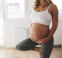An image of a pregnant woman practicing yoga.